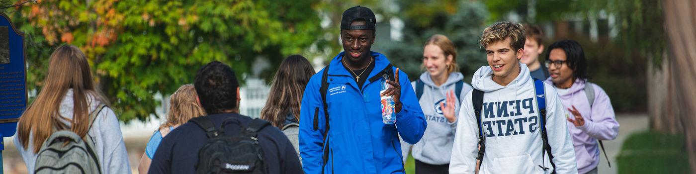 Student in Penn State gear passing each other on the way to class